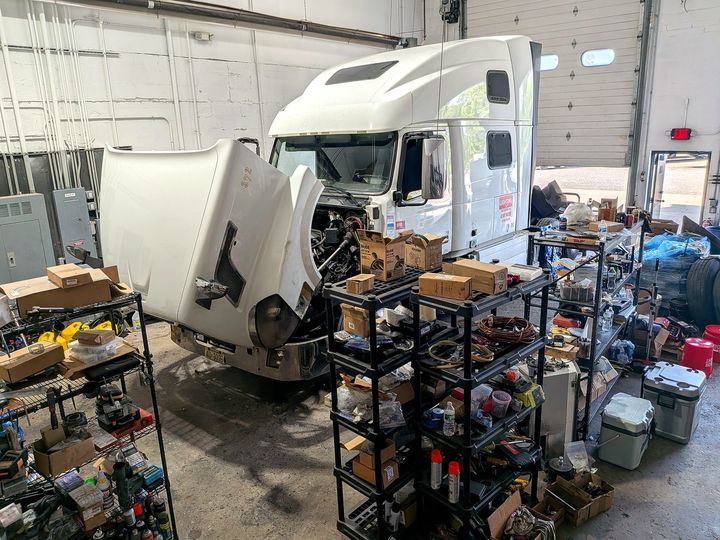 Diesel engine repair in progress on a truck cab